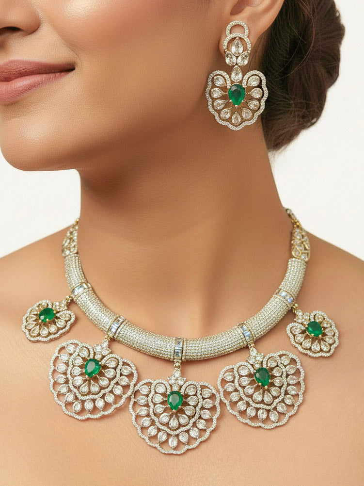 "A stunning woman wearing a glamorous artificial diamond necklace with green colored stone paired with chic earrings, perfect for bridal wear. This high-quality artificial diamond jewelry set is the ideal choice for modern brides looking for a budget-friendly option with timeless sparkle."
