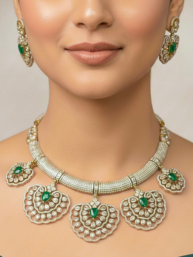 "A woman in a traditional saree, wearing a gorgeous artificial diamond necklace with green colored stone paired with diamond earrings. This artificial diamond jewelry set offers a traditional yet modern touch for Indian brides, designed to add elegance and sophistication to any occasion."
