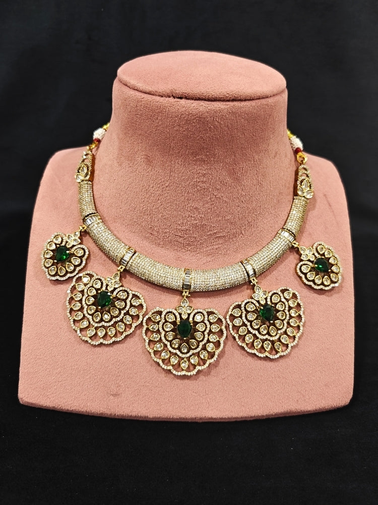 Close-up of an ornate Western American diamond Raizel Emerald Green Necklace Set (Mehendi Polish) Collar jewellery set and earrings with Colored Stone and American Diamond. Bride-to-be styled in a premium American diamond artificial necklace for her reception party.