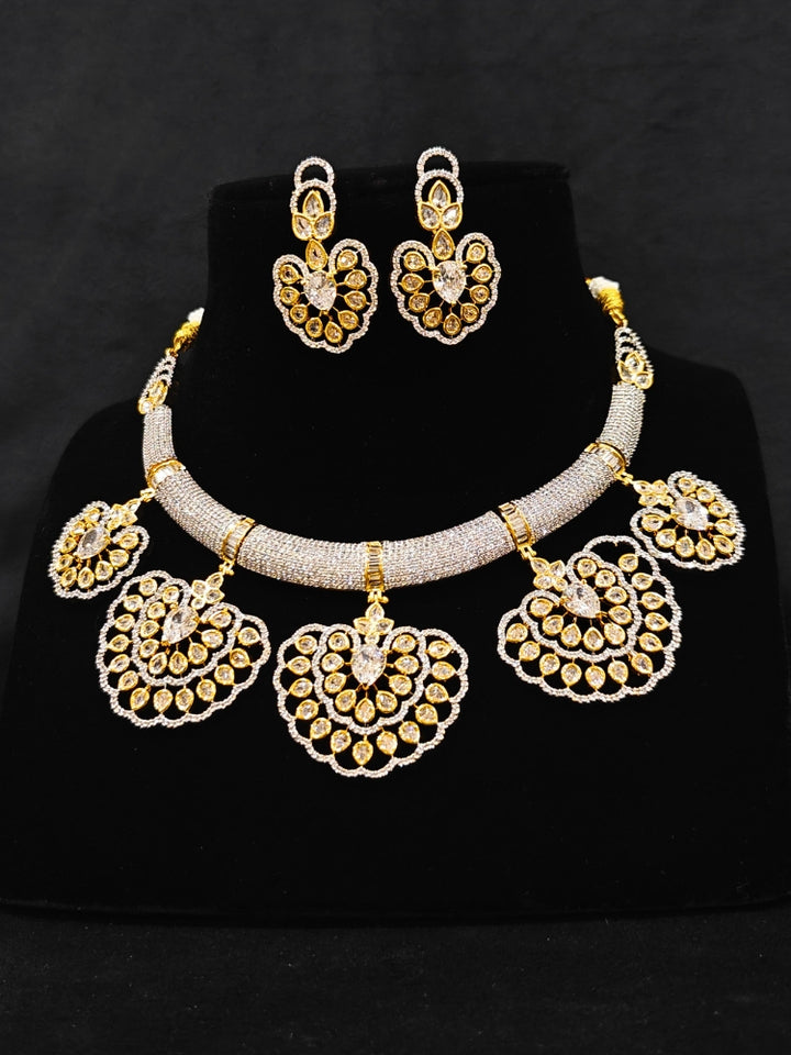 Close-up of an ornate Western American diamond Raizel Necklace Set (Dual Tone) Collar jewellery set and earrings with American Diamond. Bride-to-be styled in a premium American diamond artificial necklace for her reception party.