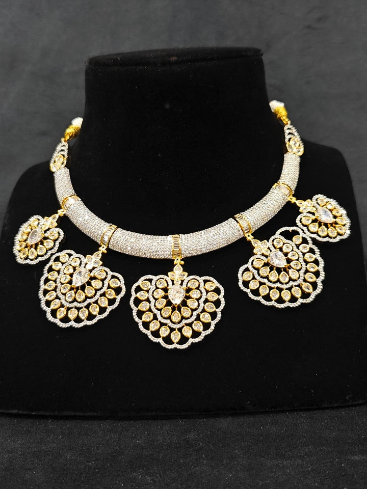 Close-up of an ornate Western American diamond Raizel Necklace Set (Dual Tone) Collar jewellery set and earrings with American Diamond. Bride-to-be styled in a premium American diamond artificial necklace for her reception party.
