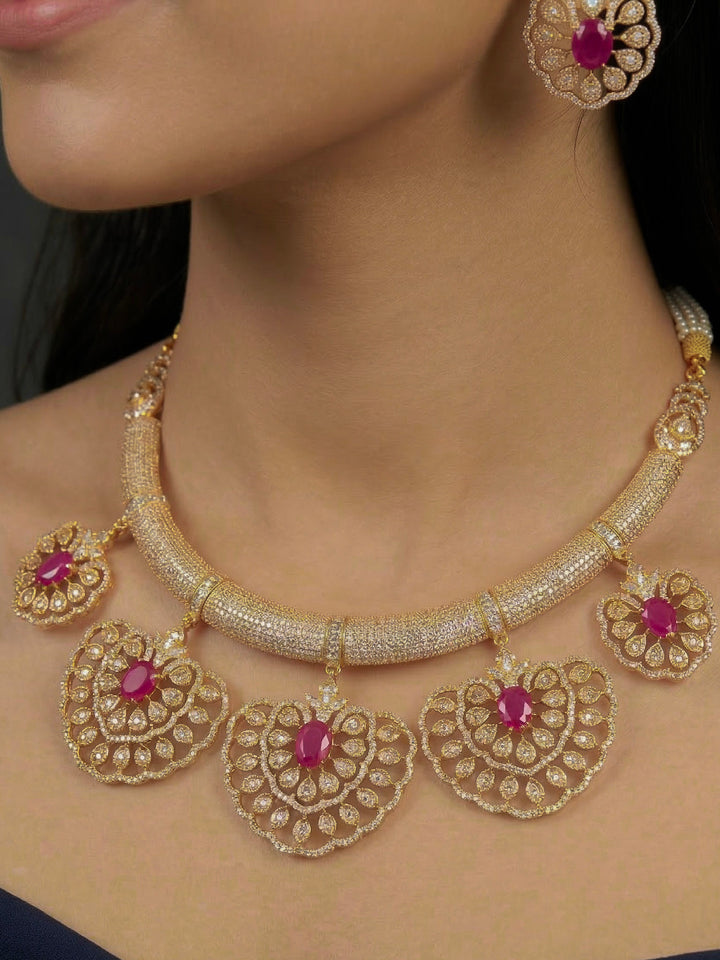 Close-up of a woman wearing an ornate Western American diamond Raizel Ruby Pink Necklace Set (Mehendi Polish) Collar jewellery set and earrings with Colored Stone and American Diamond. Woman styling a statement American diamond necklace with an off-shoulder gown for a reception.