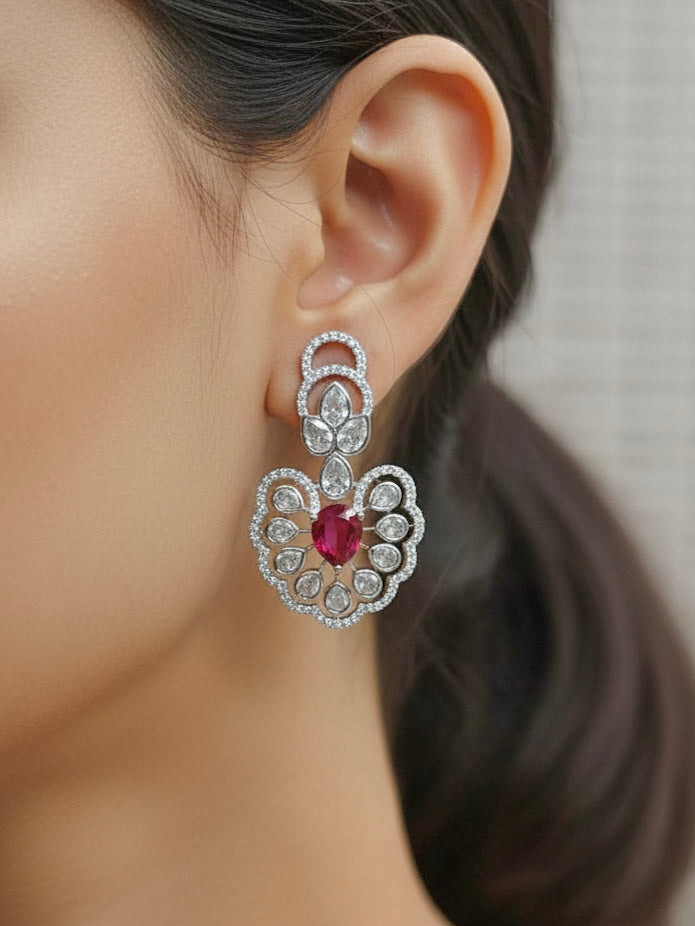 "A stunning woman wearing a glamorous artificial diamond necklace with ruby red colored stone paired with chic earrings, perfect for bridal wear. This high-quality artificial diamond jewelry set is the ideal choice for modern brides looking for a budget-friendly option with timeless sparkle."
