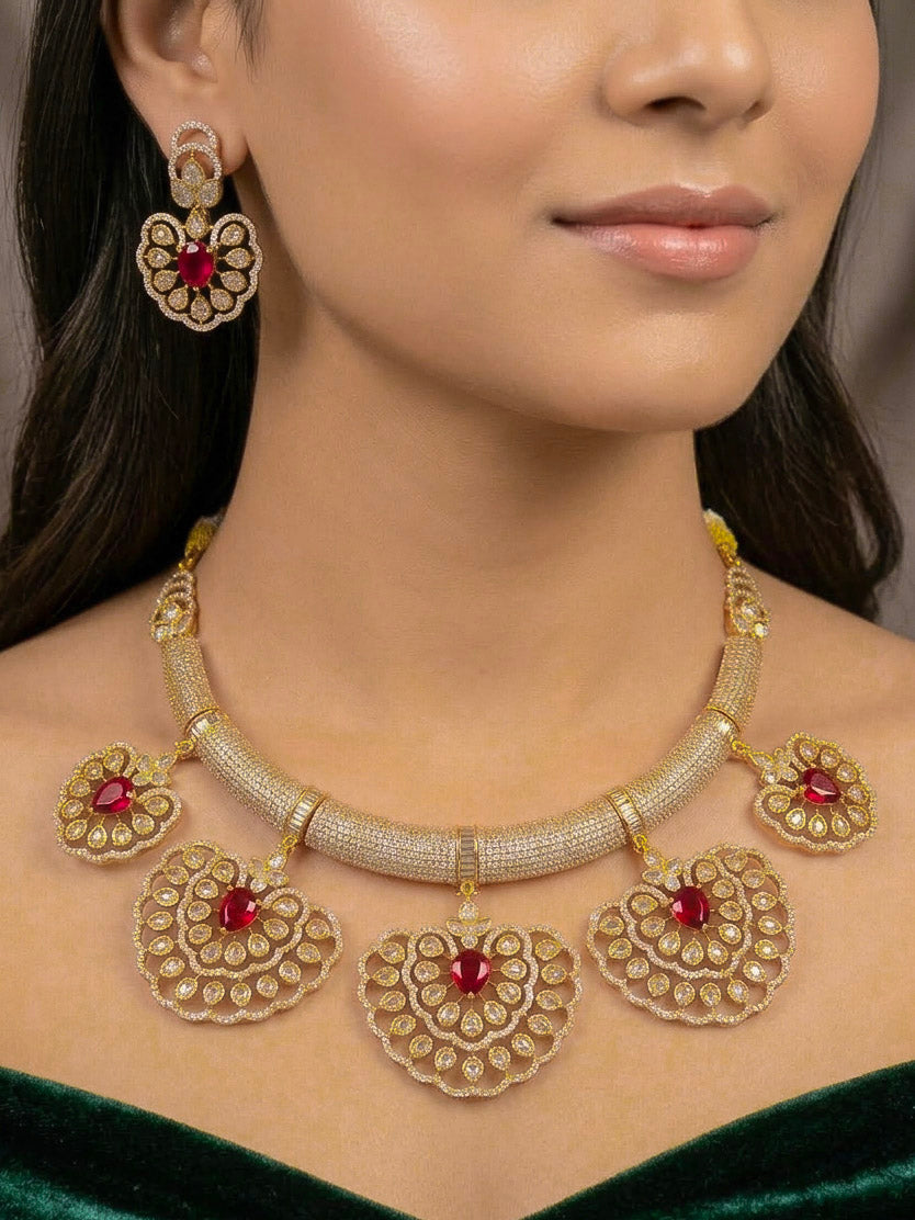 Close-up of a woman wearing an ornate Western American diamond Raizel Ruby red Necklace Set (Mehendi Polish) Collar jewellery set and earrings with Ruby Red Colored Stone and American Diamond. Bride-to-be styled in a premium American diamond artificial necklace for her reception party.