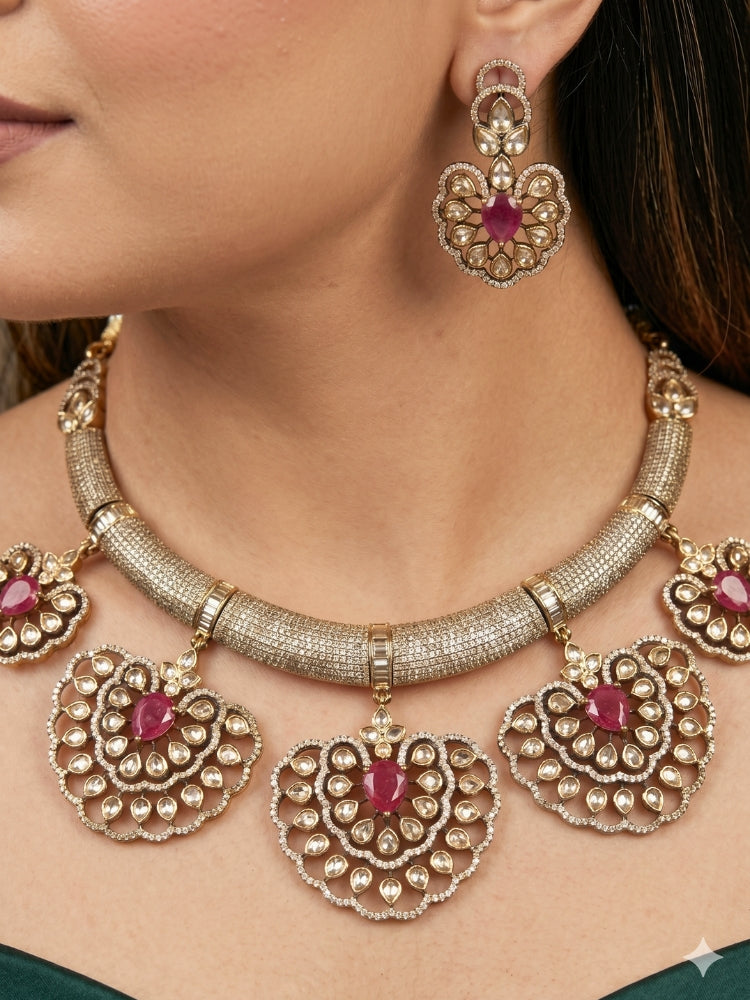 Close-up of a woman wearing an ornate Western American diamond Raizel Ruby Pink Necklace Set (Mehendi Polish) Collar jewellery set and earrings with Colored Stone and American Diamond. Woman styling a statement American diamond necklace with an off-shoulder gown for a reception.