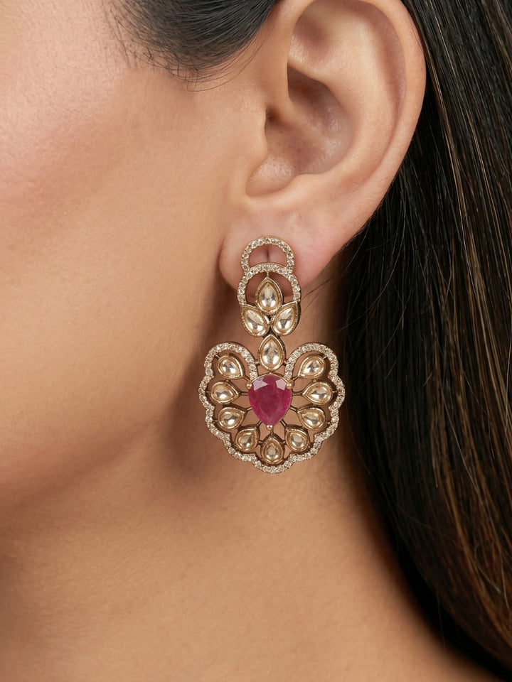Close-up of a woman wearing an ornate Western American diamond Raizel Ruby Pink Necklace Set (Mehendi Polish) Collar jewellery set and earrings with Colored Stone and American Diamond. Woman styling a statement American diamond necklace with an off-shoulder gown for a reception.