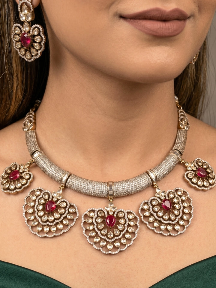 Close-up of a woman wearing an ornate Western American diamond Raizel Ruby red Necklace Set (Mehendi Polish) Collar jewellery set and earrings with Ruby Red Colored Stone and American Diamond. Bride-to-be styled in a premium American diamond artificial necklace for her reception party.