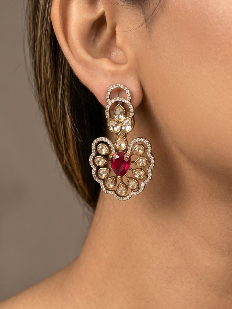 Close-up of a woman wearing an ornate Western American diamond Raizel Ruby red Necklace Set (Mehendi Polish) Collar jewellery set and earrings with Ruby Red Colored Stone and American Diamond. Bride-to-be styled in a premium American diamond artificial necklace for her reception party.