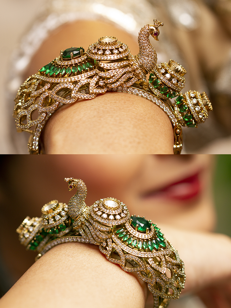 A close-up of the Rajmor Green Bracelet (Openable), featuring ornate gold work, a detailed peacock design with intricate patterns made with sparkling American diamonds and  green colored stones,  worn elegantly on the wrist—perfect as wedding jewelry.
