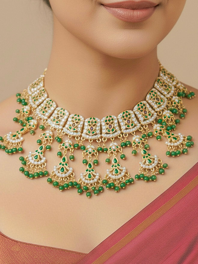 Close-up of a woman wearing an ornate traditional jadau gold jewellery set and jadau earrings with Beads and gemstones. Woman pairing a traditional Jadau necklace with a silk saree.Woman wearing a royal Jadau necklace for festive events in India.