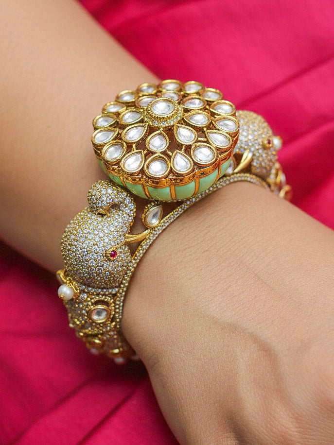 Close-up of a woman wearing an ornate traditional Diamond Mint Green Bracelet with American Diamond, Meenakari and Kundan. Festive Diwali outfit styled with an American diamond artificial Bracelet. Wedding guest wearing a minimal artificial American Diamond bracelet.