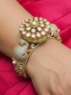 Close-up of a woman wearing an ornate traditional Diamond Mint Green Bracelet with American Diamond, Meenakari and Kundan. Festive Diwali outfit styled with an American diamond artificial Bracelet. Wedding guest wearing a minimal artificial American Diamond bracelet.