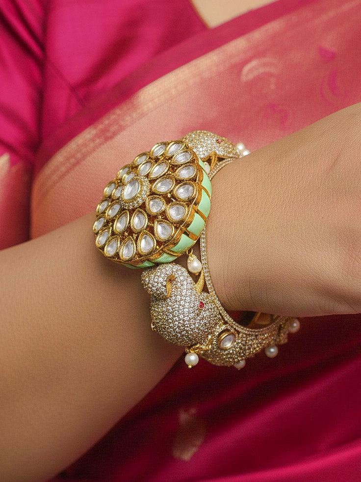 Close-up of a woman wearing an ornate traditional Diamond Mint Green Bracelet with American Diamond, Meenakari and Kundan. Festive Diwali outfit styled with an American diamond artificial Bracelet. Wedding guest wearing a minimal artificial American Diamond bracelet.