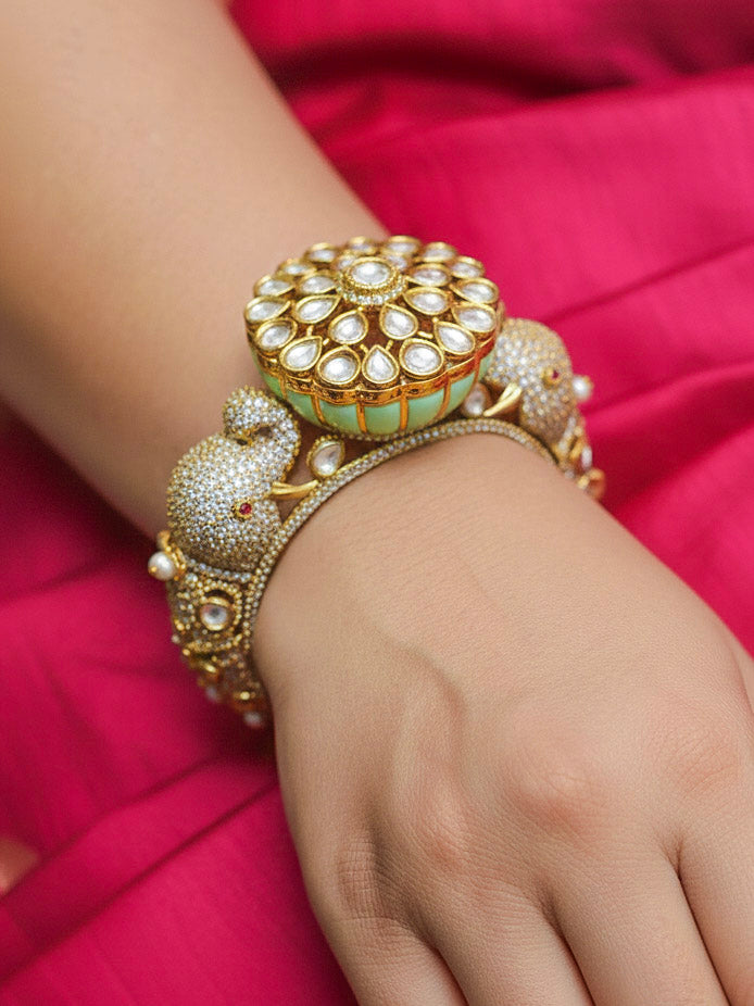 Close-up of a woman wearing an ornate traditional Diamond Mint Green Bracelet with American Diamond, Meenakari and Kundan. Festive Diwali outfit styled with an American diamond artificial Bracelet. Wedding guest wearing a minimal artificial American Diamond bracelet.