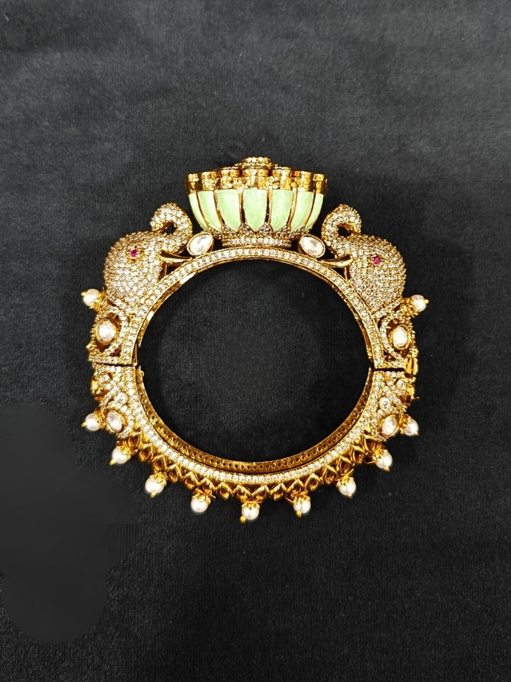 Close-up of an ornate traditional Diamond Mint Green Bracelet with American Diamond, Meenakari and Kundan. Festive Diwali outfit styled with an American diamond artificial Bracelet. Wedding guest wearing a minimal artificial American Diamond bracelet.
