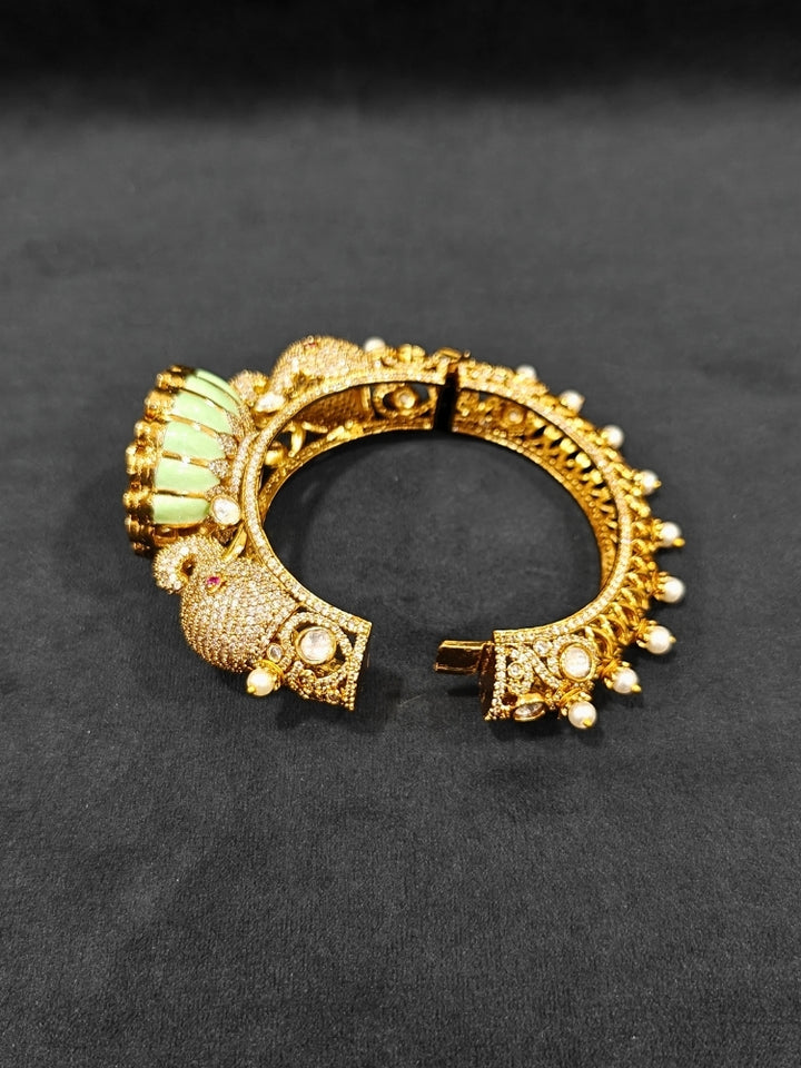 Close-up of an ornate traditional Diamond Mint Green Bracelet with American Diamond, Meenakari and Kundan. Festive Diwali outfit styled with an American diamond artificial Bracelet. Wedding guest wearing a minimal artificial American Diamond bracelet.