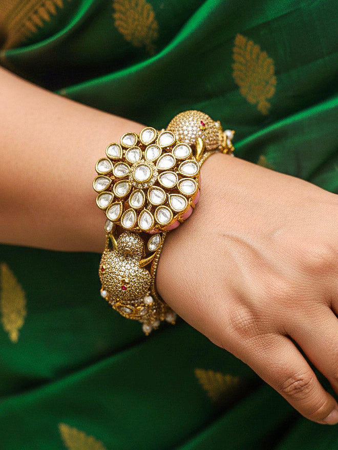 Close-up of a woman wearing an ornate traditional Diamond Mint pink Bracelet with American Diamond, Meenakari and Kundan. Festive Diwali outfit styled with an American diamond artificial Bracelet. Wedding guest wearing a minimal artificial American Diamond bracelet.