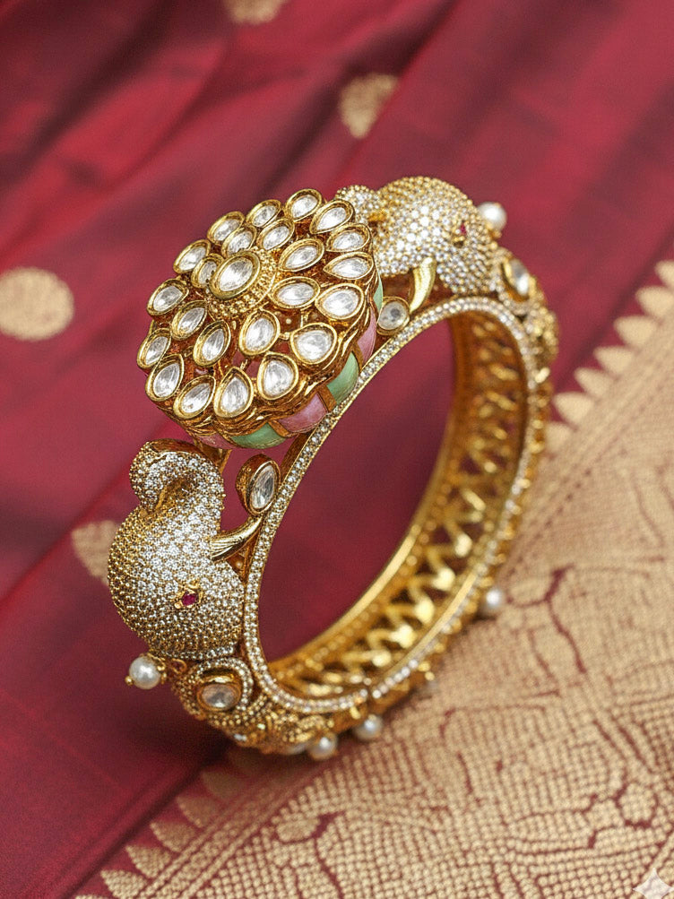 Close-up of an ornate traditional Diamond Mint Green & pink Bracelet with American Diamond, Meenakari and Kundan. Festive Diwali outfit styled with an American diamond artificial Bracelet. Wedding guest wearing a minimal artificial American Diamond bracelet.