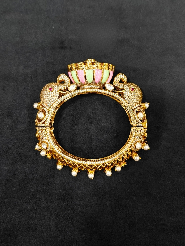 Close-up of an ornate traditional Diamond Mint Green & pink Bracelet with American Diamond, Meenakari and Kundan. Festive Diwali outfit styled with an American diamond artificial Bracelet. Wedding guest wearing a minimal artificial American Diamond bracelet.