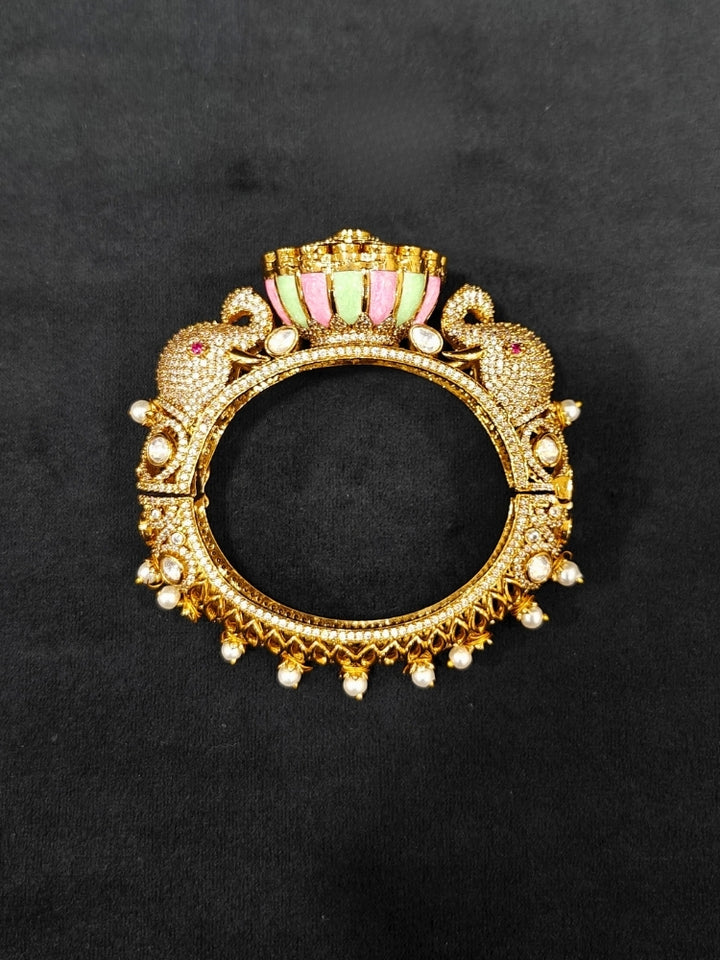 Close-up of an ornate traditional Diamond Mint Green & pink Bracelet with American Diamond, Meenakari and Kundan. Festive Diwali outfit styled with an American diamond artificial Bracelet. Wedding guest wearing a minimal artificial American Diamond bracelet.