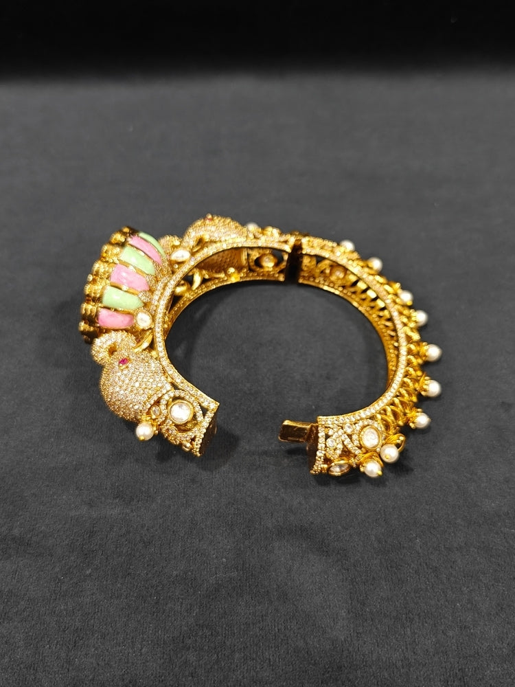 Close-up of an ornate traditional Diamond Mint Green & pink Bracelet with American Diamond, Meenakari and Kundan. Festive Diwali outfit styled with an American diamond artificial Bracelet. Wedding guest wearing a minimal artificial American Diamond bracelet.