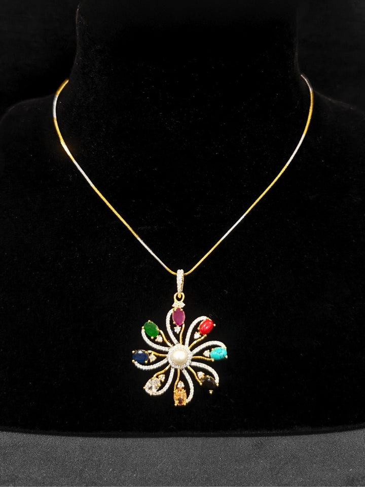 Close-up of an ornate Indo-Western Multi-Color (gold Polish) Pendant set and earrings with American Diamond and Colored Stones. Mehendi function outfit styled with a lightweight American Diamond Pendant. Close-up of high-quality artificial American Diamond Pendant craftsmanship.