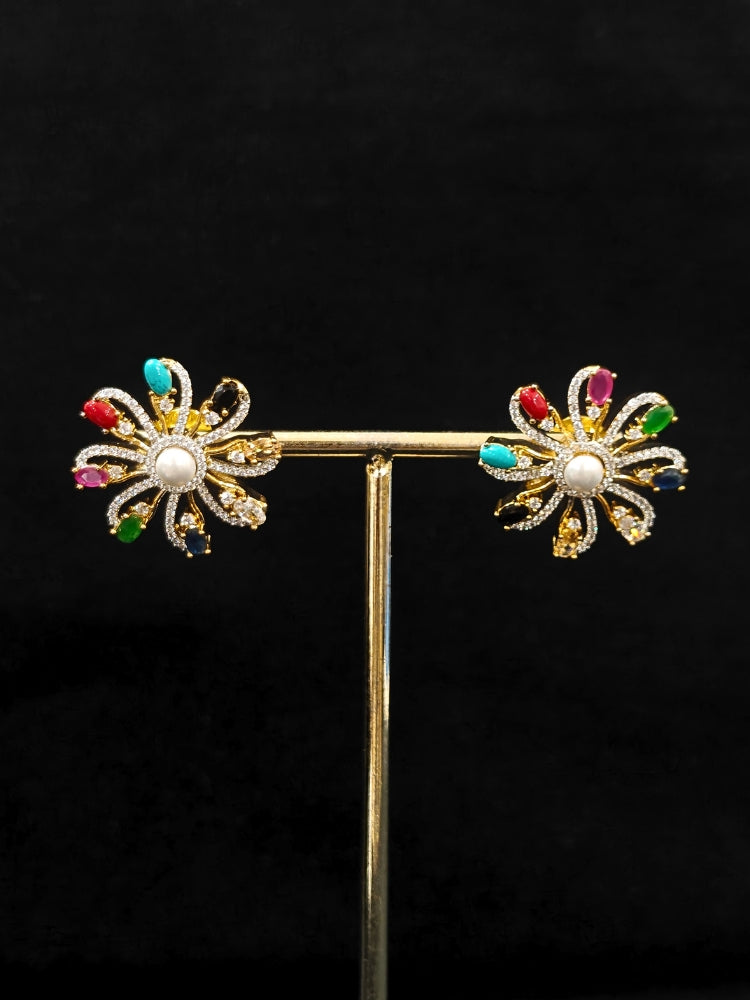 Close-up of an ornate Indo-Western Multi-Color (gold Polish) Pendant set and earrings with American Diamond and Colored Stones. Mehendi function outfit styled with a lightweight American Diamond Pendant. Close-up of high-quality artificial American Diamond Pendant craftsmanship.