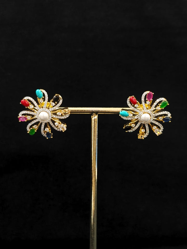 Close-up of an ornate Indo-Western Multi-Color (gold Polish) Pendant set and earrings with American Diamond and Colored Stones. Mehendi function outfit styled with a lightweight American Diamond Pendant. Close-up of high-quality artificial American Diamond Pendant craftsmanship.