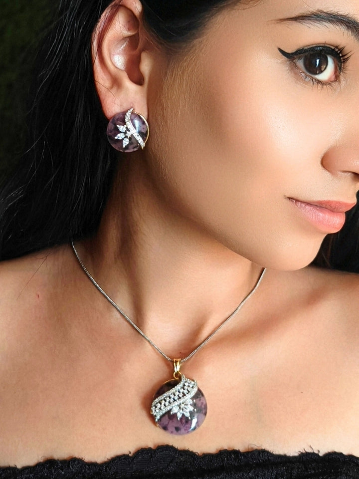 Close-up of a woman wearing an ornate Western Purple Diamond Pendant Set with American Diamons and Purple Colored Stones. Festive Diwali outfit styled with an American diamond artificial Lightweight Pendant Set. Close-up shot of a high-quality American diamond artificial Pendant worn for festive celebrations.
