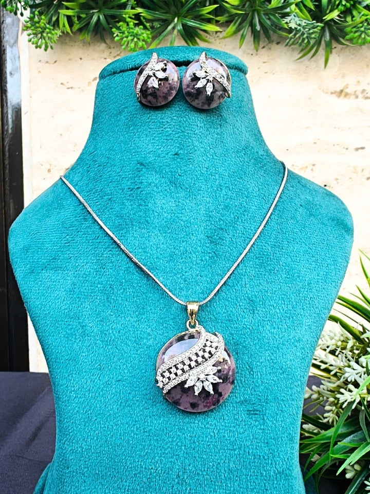 Close-up of an ornate Western Purple Diamond Pendant Set with American Diamons and Purple Colored Stones. Festive Diwali outfit styled with an American diamond artificial Lightweight Pendant Set. Close-up shot of a high-quality American diamond artificial Pendant worn for festive celebrations.