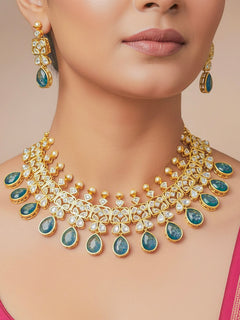 Close-up of a woman wearing an ornate traditional (Gold Polish) Blue Collar jewellery set and earrings with Diamond Polki, Monalisa Stone and Colored Stones. Wedding guest wearing a sparkling American diamond necklace with a saree. A graceful woman wearing a trending American diamond necklace for a 2026 wedding celebration.