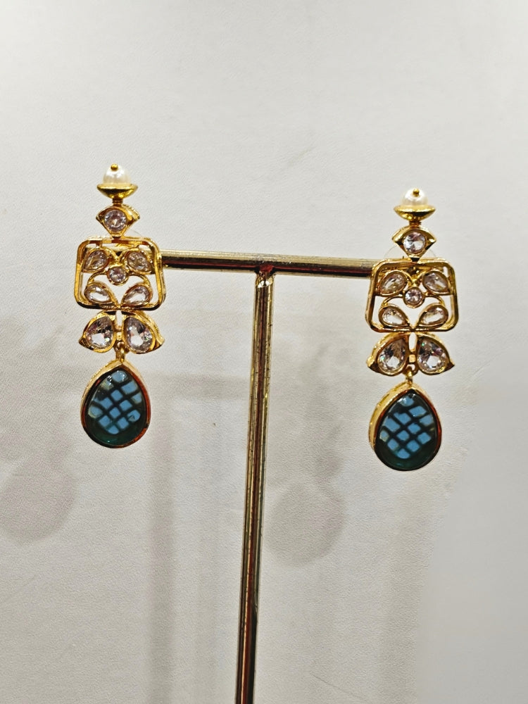 Close-up of an ornate traditional (Gold Polish) Blue Collar jewellery set and earrings with Diamond Polki, Monalisa Stone and Colored Stones. Wedding guest wearing a sparkling American diamond necklace with a saree. A graceful woman wearing a trending American diamond necklace for a 2026 wedding celebration.