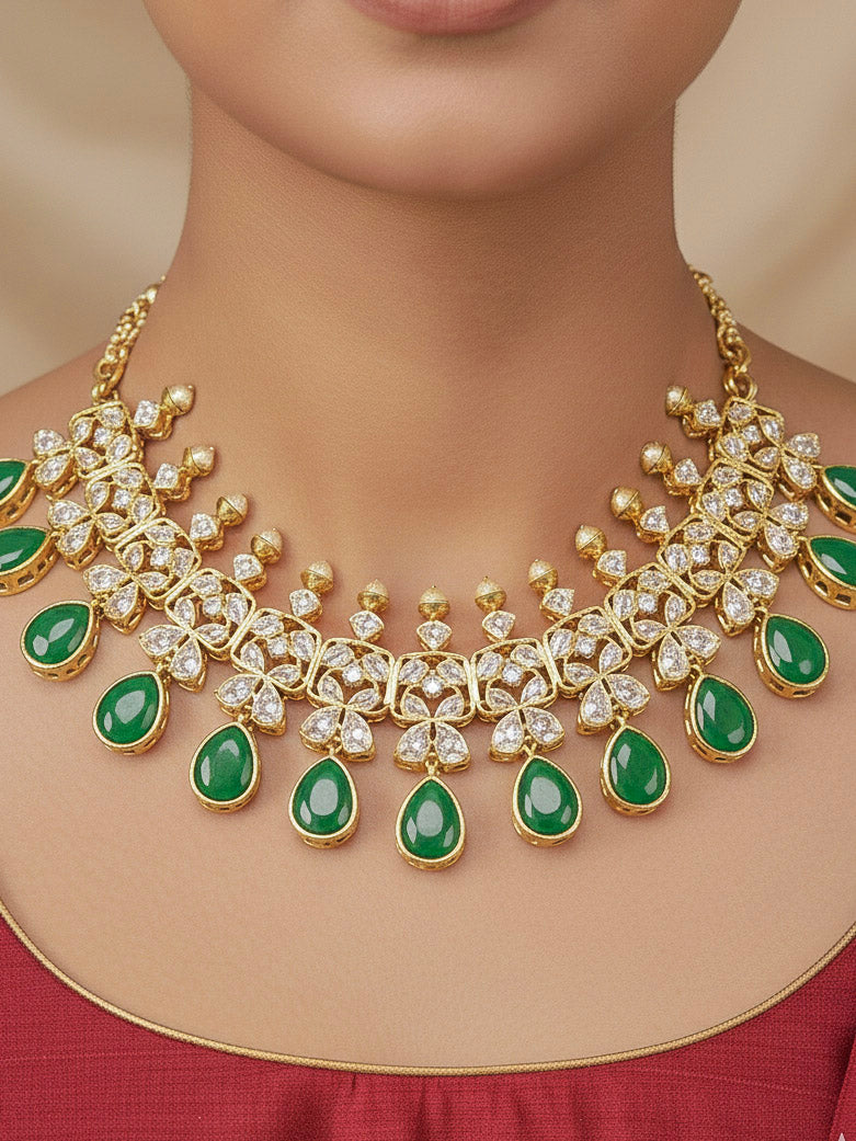 Close-up of a woman wearing an ornate traditional (Gold Polish) Dark Green Collar jewellery set and earrings with Diamond Polki, Monalisa Stone and Colored Stones. Wedding guest wearing a sparkling American diamond necklace with a saree. A graceful woman wearing a trending American diamond necklace for a 2026 wedding celebration.