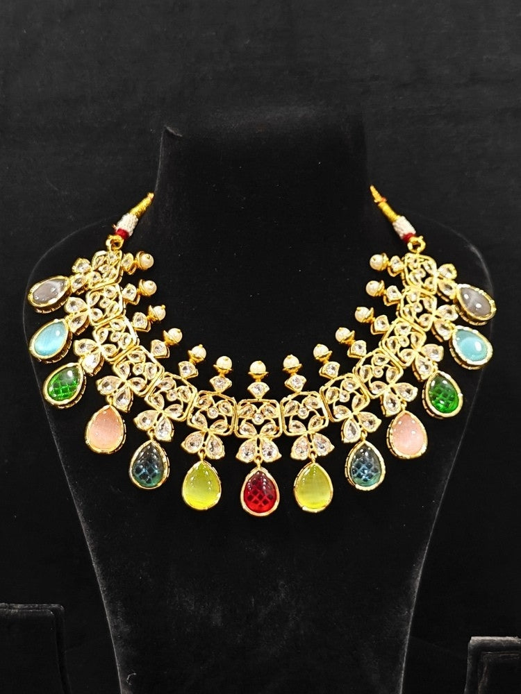 Close-up of an ornate traditional (Gold Polish) Multi-Color Collar jewellery set and earrings with Diamond Polki, Monalisa Stone and Colored Stones. Wedding guest wearing a sparkling American diamond necklace with a saree. A graceful woman wearing a trending American diamond necklace for a 2026 wedding celebration.