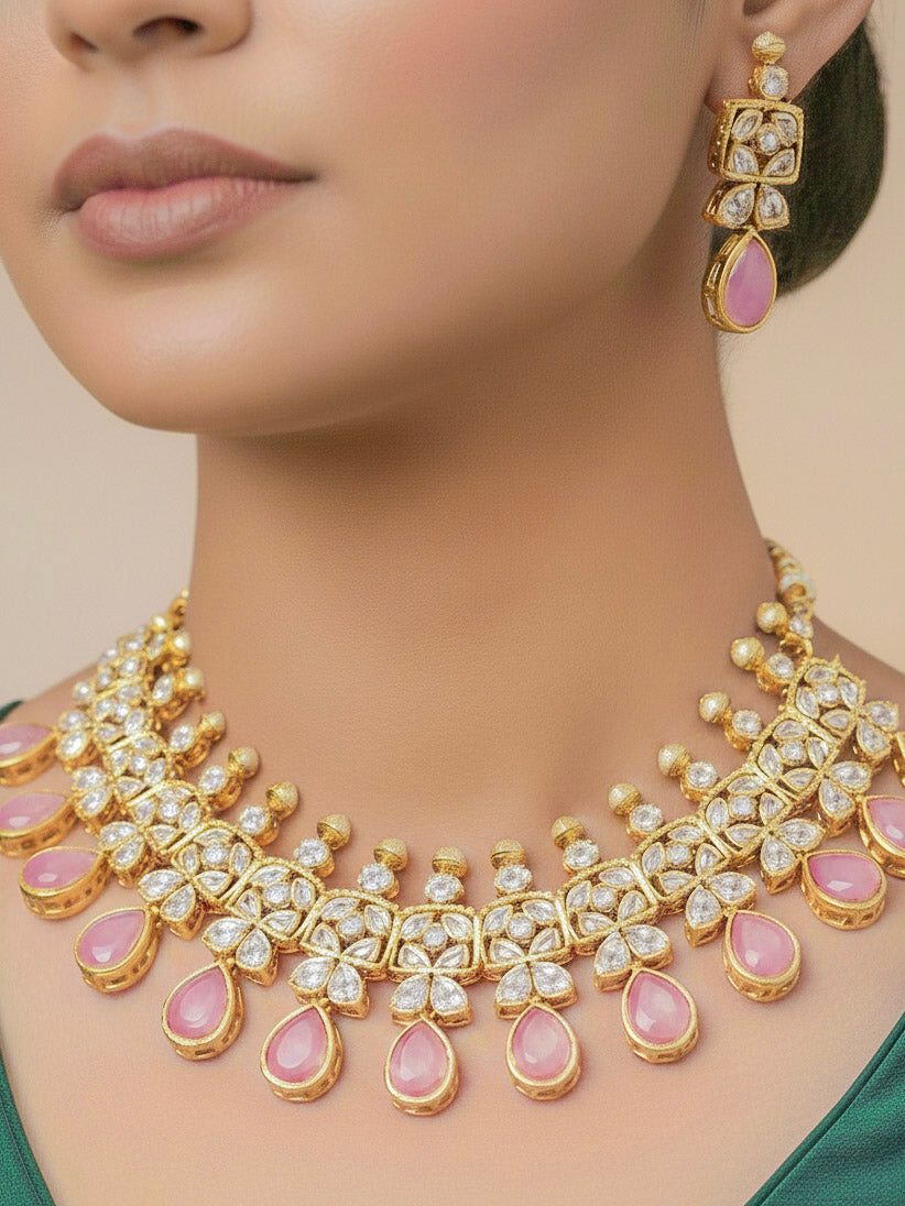 Close-up of a woman wearing an ornate traditional (Gold Polish) Pink Collar jewellery set and earrings with Diamond Polki, Monalisa Stone and Colored Stones. Wedding guest wearing a sparkling American diamond necklace with a saree. A graceful woman wearing a trending American diamond necklace for a 2026 wedding celebration.