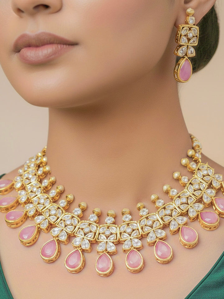 Close-up of a woman wearing an ornate traditional (Gold Polish) Pink Collar jewellery set and earrings with Diamond Polki, Monalisa Stone and Colored Stones. Wedding guest wearing a sparkling American diamond necklace with a saree. A graceful woman wearing a trending American diamond necklace for a 2026 wedding celebration.