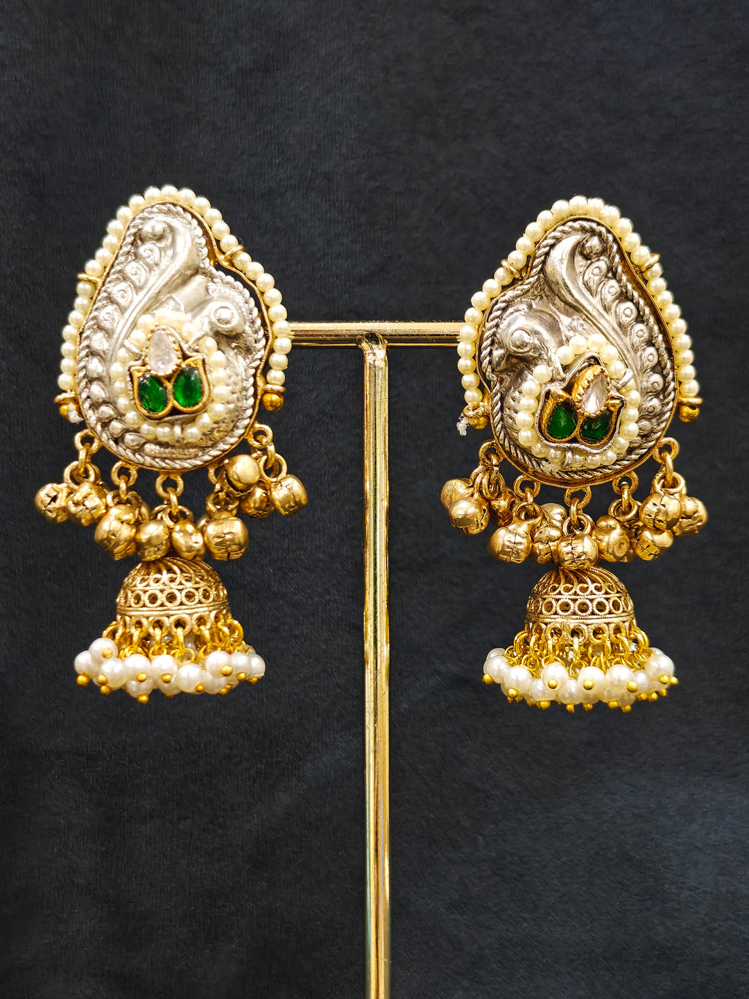 Close-up of an ornate traditional KASHMIRI-BOHO Meenakari Green and Ruby Pink gold Collar jewellery set and earrings with Pachi Kundan, Silver Balls, Pearls, Doublet Stones, Tumble Stone, Ghungroo and Meenakari. Festive celebration look enhanced with traditional Meenakari jewelry. 