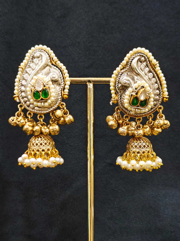 Close-up of an ornate traditional KASHMIRI-BOHO Meenakari Green and Ruby Pink gold Collar jewellery set and earrings with Pachi Kundan, Silver Balls, Pearls, Doublet Stones, Tumble Stone, Ghungroo and Meenakari. Festive celebration look enhanced with traditional Meenakari jewelry. 
