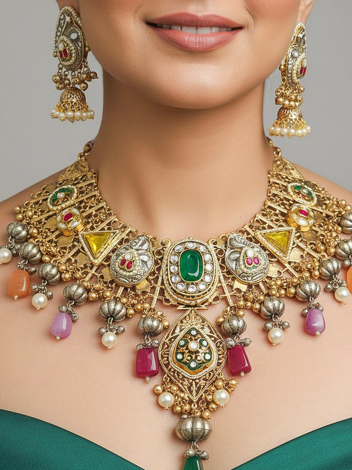 Close-up of a woman wearing an ornate traditional KASHMIRI-BOHO Meenakari Green & Yellow gold Collar jewellery set and earrings with Pachi Kundan, Silver Balls, Pearls, Doublet Stones, Tumble Stone, Ghungroo and Meenakari. Festive celebration look enhanced with traditional Meenakari jewelry. 