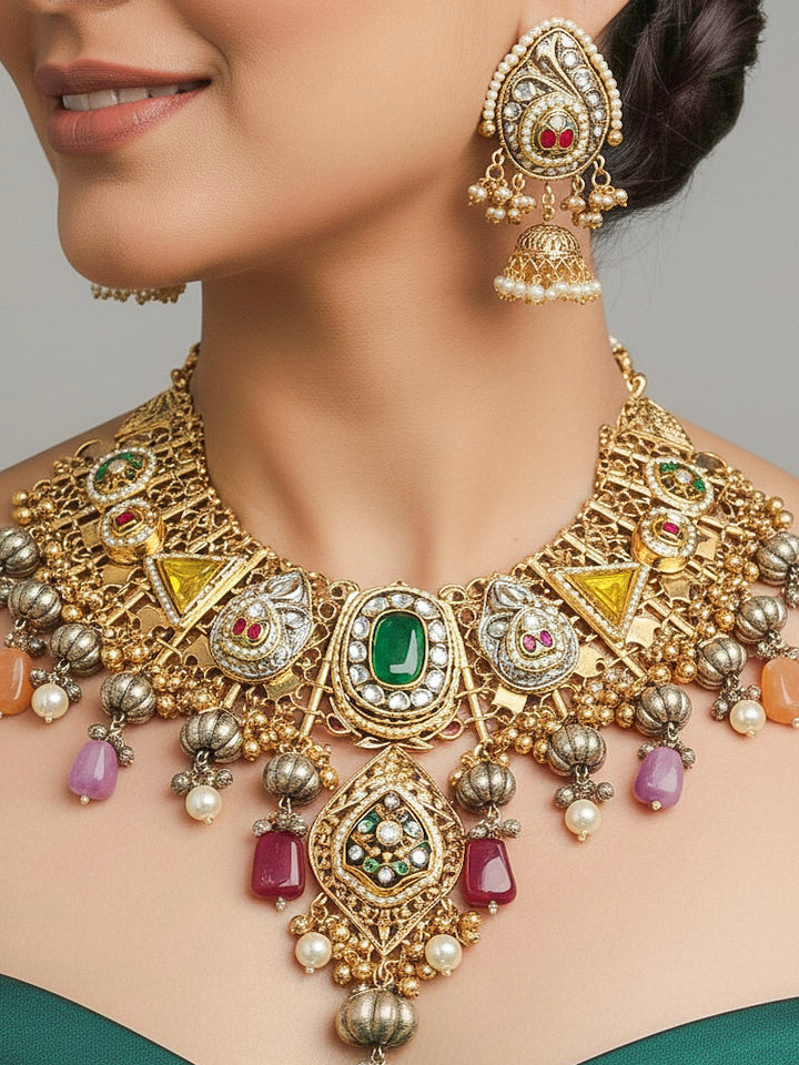 Close-up of a woman wearing an ornate traditional KASHMIRI-BOHO Meenakari Green & Yellow gold Collar jewellery set and earrings with Pachi Kundan, Silver Balls, Pearls, Doublet Stones, Tumble Stone, Ghungroo and Meenakari. Festive celebration look enhanced with traditional Meenakari jewelry. 