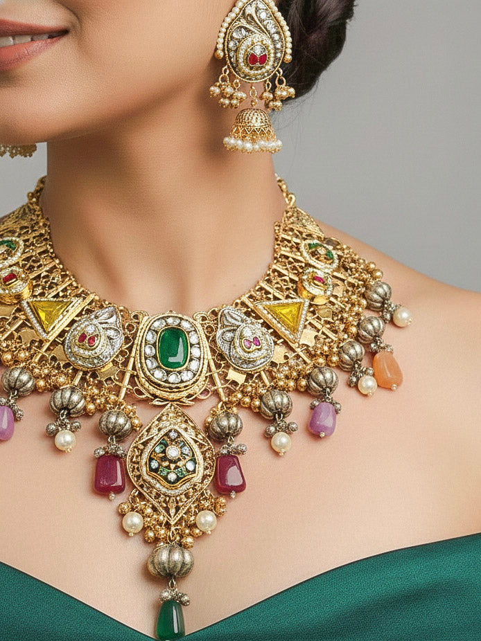Close-up of a woman wearing an ornate traditional KASHMIRI-BOHO Meenakari Green & Yellow gold Collar jewellery set and earrings with Pachi Kundan, Silver Balls, Pearls, Doublet Stones, Tumble Stone, Ghungroo and Meenakari. Festive celebration look enhanced with traditional Meenakari jewelry. 