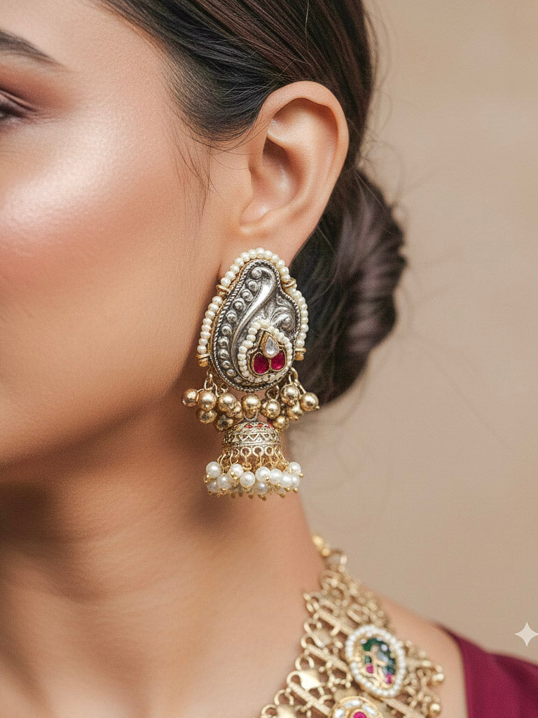 Close-up of a woman wearing an ornate traditional KASHMIRI-BOHO Meenakari Green & Yellow gold Collar jewellery set and earrings with Pachi Kundan, Silver Balls, Pearls, Doublet Stones, Tumble Stone, Ghungroo and Meenakari. Festive celebration look enhanced with traditional Meenakari jewelry. 