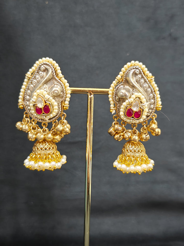 Close-up of an ornate traditional KASHMIRI-BOHO Meenakari Green & Yellow gold Collar jewellery set and earrings with Pachi Kundan, Silver Balls, Pearls, Doublet Stones, Tumble Stone, Ghungroo and Meenakari. Festive celebration look enhanced with traditional Meenakari jewelry. 