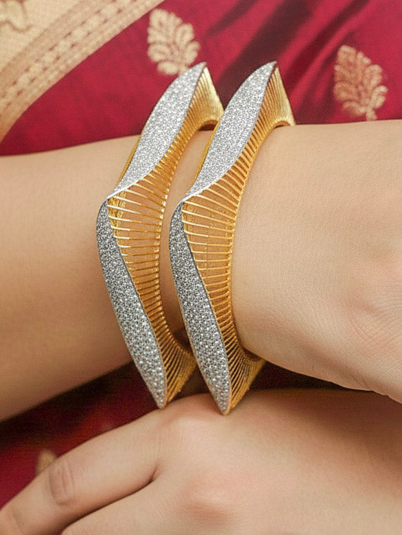 Close-up of a woman wearing an ornate Indo-western Diamond gold Bangles with American Diamond and Filigree work. Woman stacking artificial American Diamond bangles for a festive Diwali celebration. Close-up of sparkling artificial American Diamond bangles for party wear.