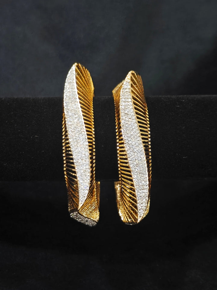 Close-up of an ornate Indo-western Diamond gold Bangles with American Diamond and Filigree work. Stacking artificial American Diamond bangles for a festive Diwali celebration. Close-up of sparkling artificial American Diamond bangles for party wear.
