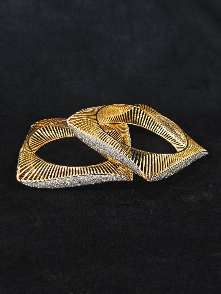 Close-up of an ornate Indo-western Diamond gold Bangles with American Diamond and Filigree work. Stacking artificial American Diamond bangles for a festive Diwali celebration. Close-up of sparkling artificial American Diamond bangles for party wear.