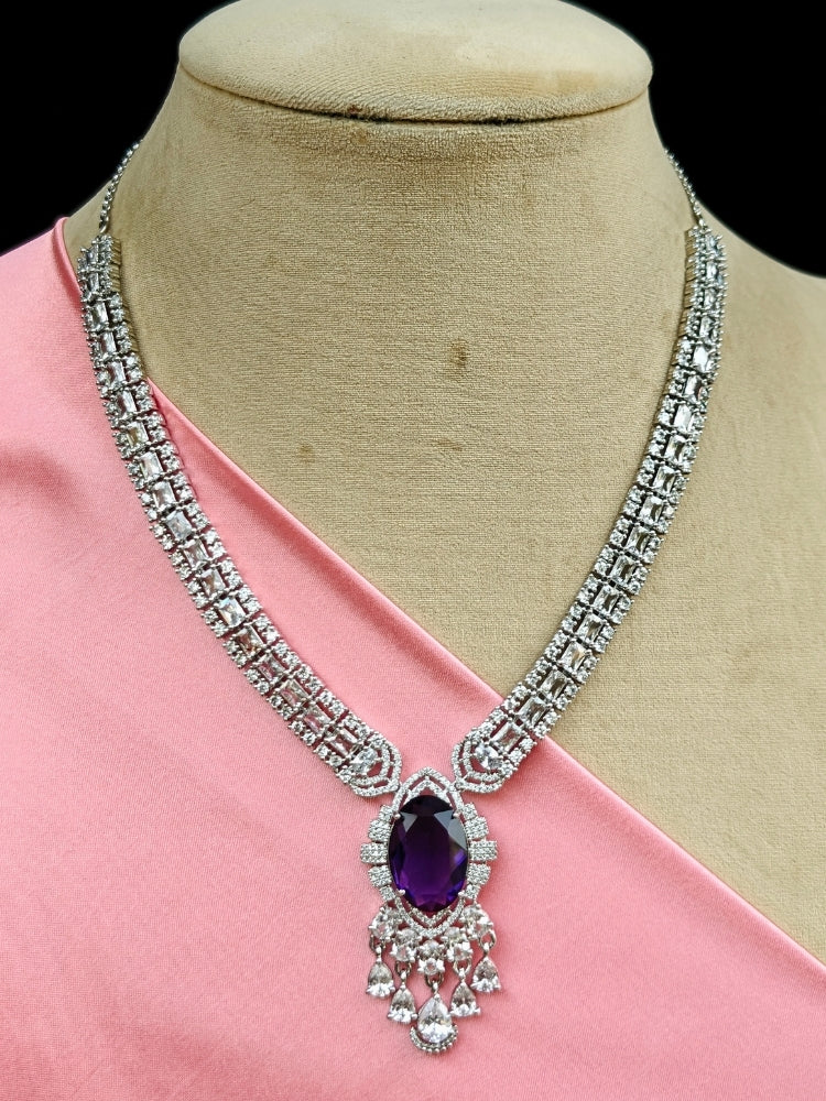 Close-up of a luxurious artificial diamond jewelry featuring a designer diamond necklace with purple colored stone and earrings set, crafted for bridal fashion and high-end weddings. This beautiful diamond jewelry set offers the brilliance of real diamonds at an affordable price.