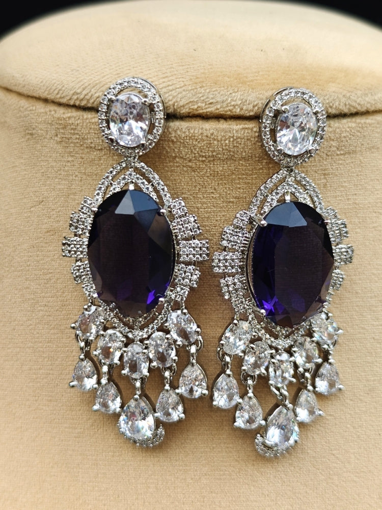 Close-up of a luxurious artificial diamond jewelry featuring a designer diamond necklace with purple colored stone and earrings set, crafted for bridal fashion and high-end weddings. This beautiful diamond jewelry set offers the brilliance of real diamonds at an affordable price.