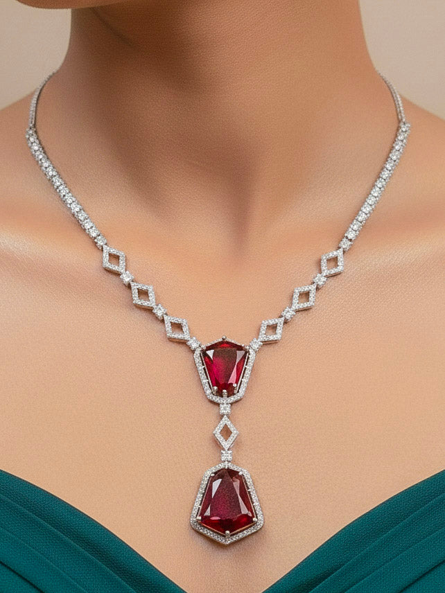 Close-up of a woman wearing an ornate Western Red (Silver Polish) Diamond jewellery set and earrings with American Diamond and Colored Stones. Festive Diwali outfit styled with an American diamond artificial necklace. Close-up of a party look featuring a premium American diamond necklace.