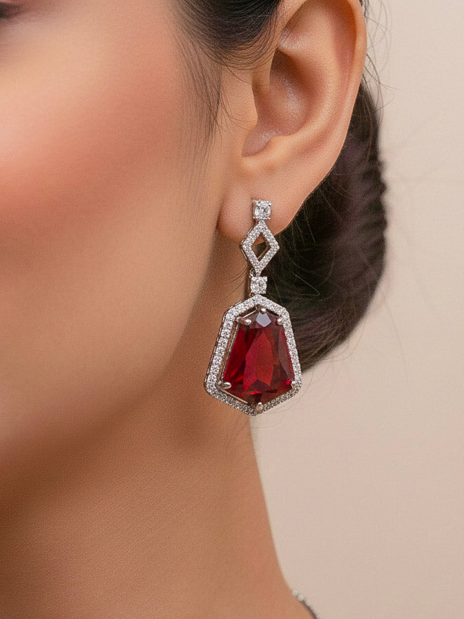 Close-up of a woman wearing an ornate Western Red (Silver Polish) Diamond jewellery set and earrings with American Diamond and Colored Stones. Festive Diwali outfit styled with an American diamond artificial necklace. Close-up of a party look featuring a premium American diamond necklace.